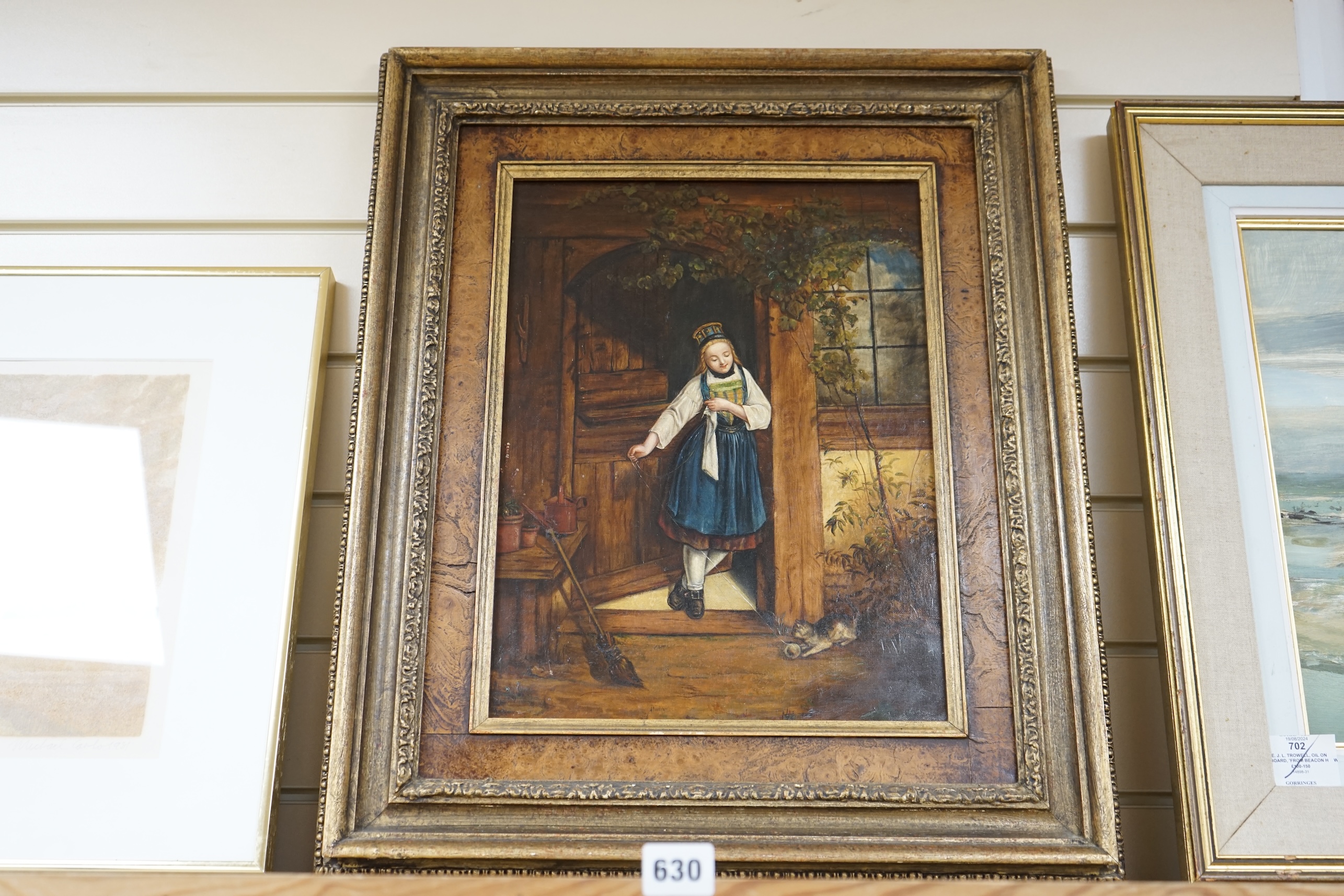 19th century, Dutch School, oil on canvas, Girl and kitten beneath a doorway, unsigned, 39 x 28cm. Condition - fair, repair visible to the reverse of the canvas